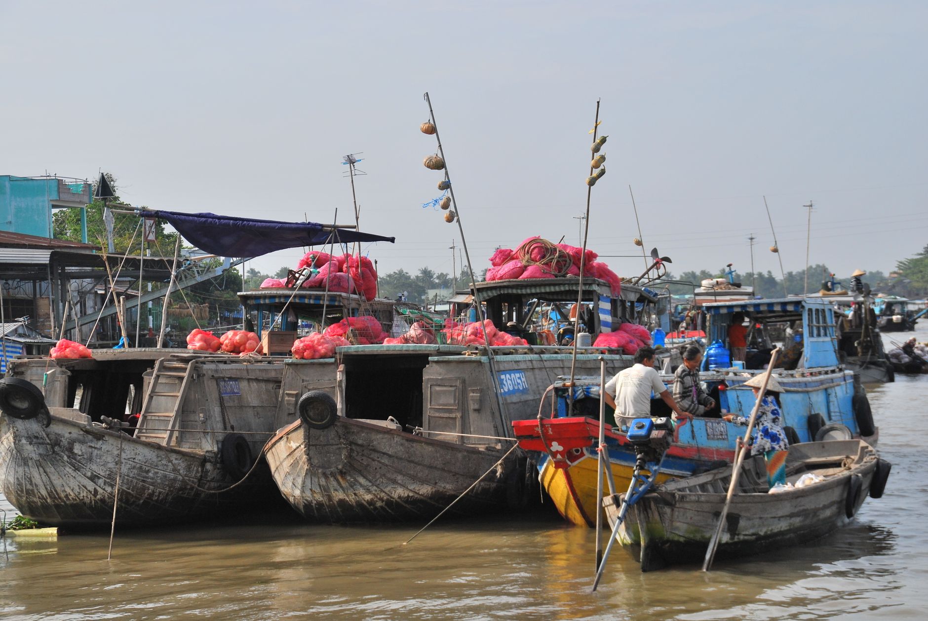 Trading boats loaded with goods at a Mekong Delta floating market, southern Vietnam
