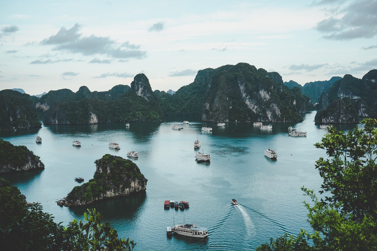 Aerial view of cruise boats scattered among limestone karst islands in Ha Long Bay, Vietnam