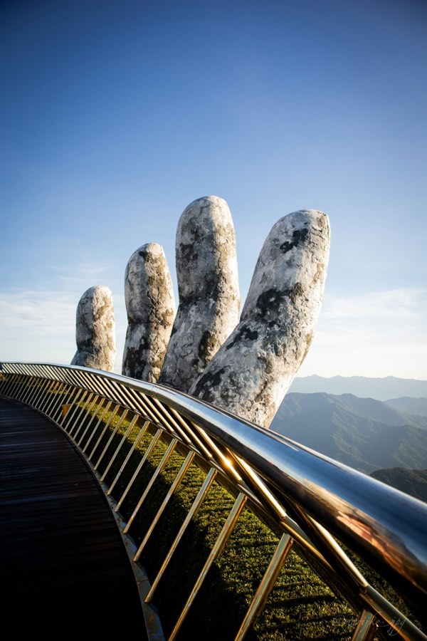 The Golden Bridge held by giant stone hands at Ba Na Hills, Da Nang, Vietnam