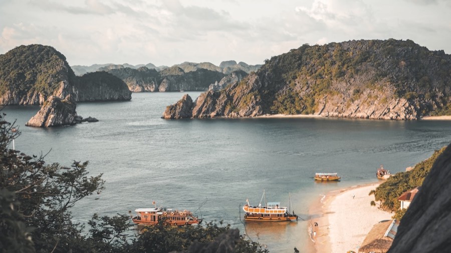 Cruise boat near limestone mountains in Ha Long Bay, Vietnam