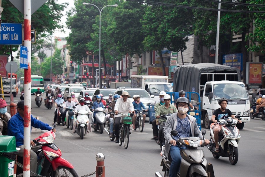 Busy street in Ho Chi Minh City with motorbikes and traffic - Saigon's iconic urban energy as seen on city tours