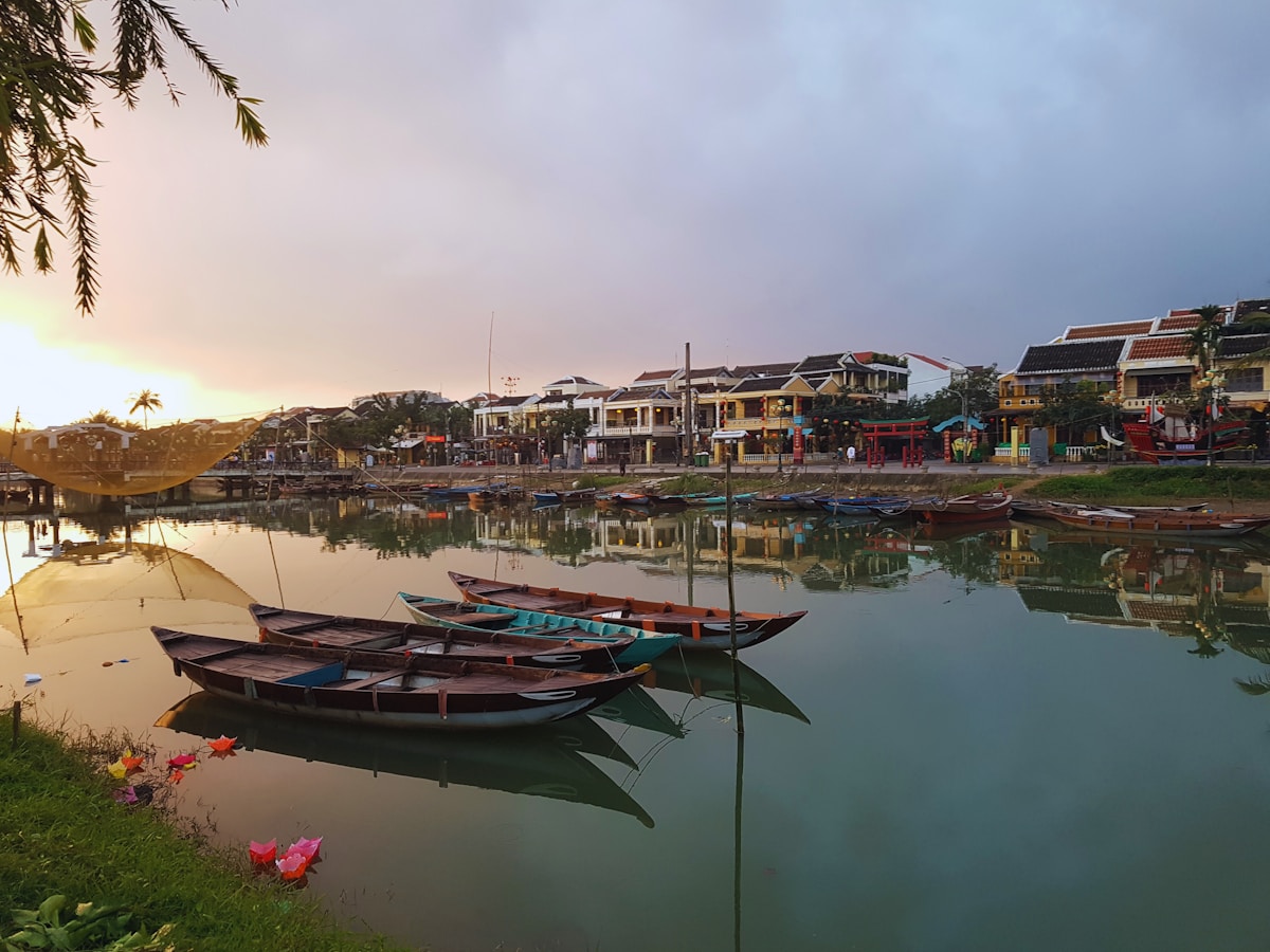 Wooden boats moored on the Thu Bon River near Hoi An Ancient Town, Vietnam