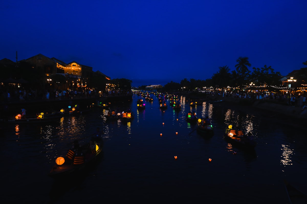 Glowing lanterns floating on the Thu Bon River in Hoi An at night