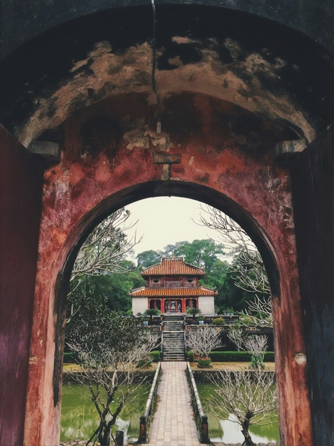 Imperial Citadel gate framing a traditional Vietnamese pagoda, Hue - the base city for DMZ day tours north to the 17th parallel