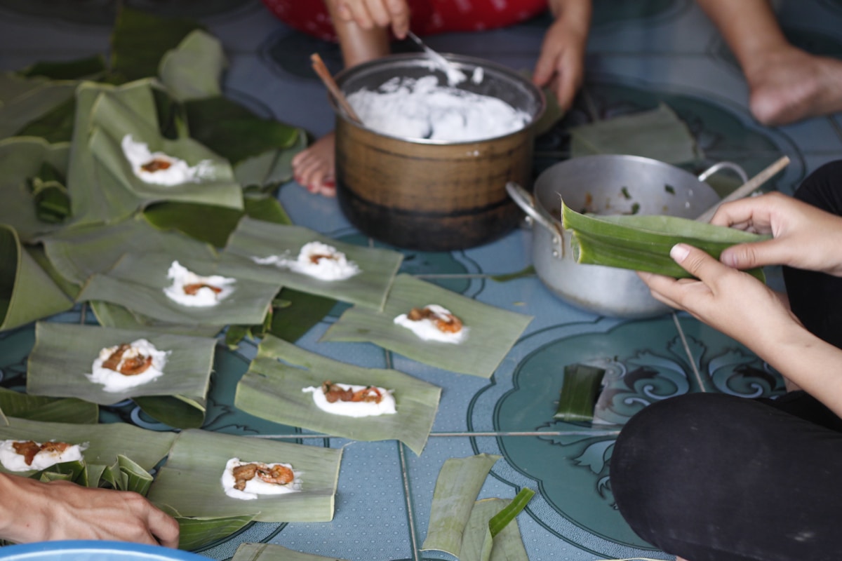 Local women preparing traditional food with banana leaves, Hue, central Vietnam