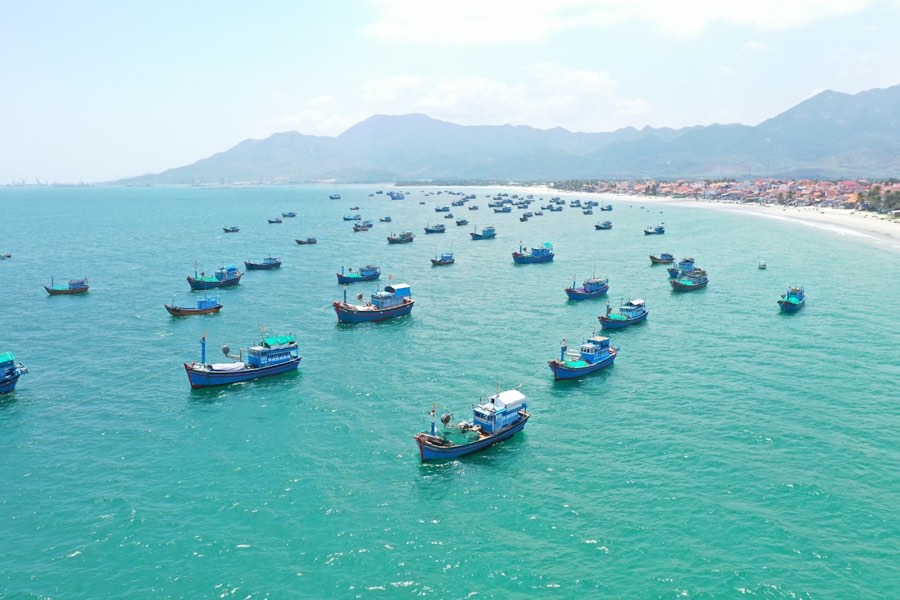 Fishing boats at sea with mountains in the background, central Vietnam coast