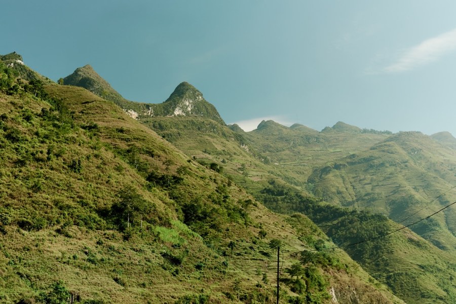 Lush green mountains under clear blue sky, Mai Chau, Vietnam