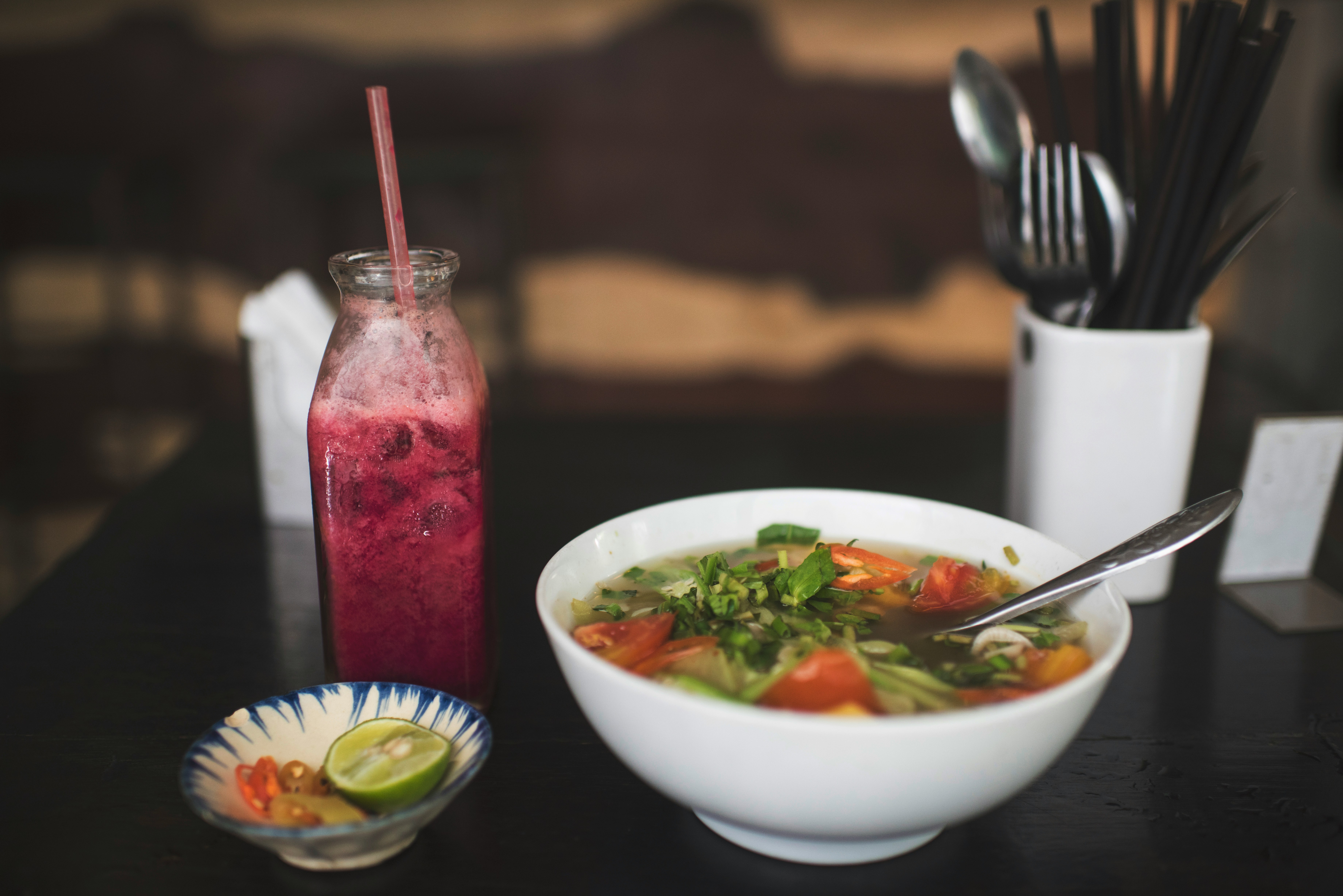 Bowl of Vietnamese soup with fresh herbs, Mui Ne, Vietnam