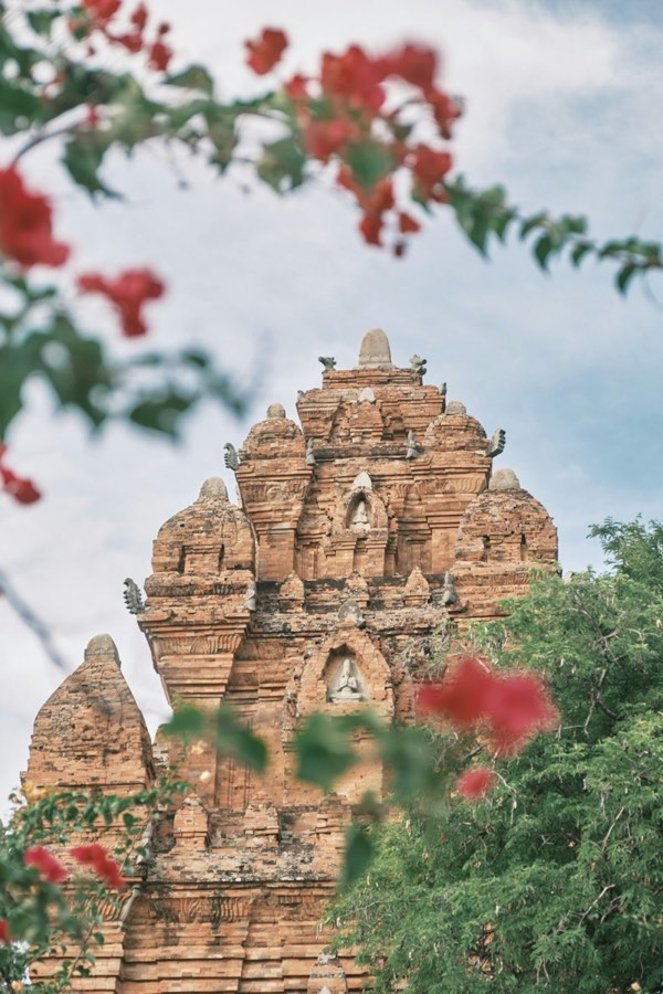 Ancient Cham brick tower rising through tropical foliage in central Vietnam