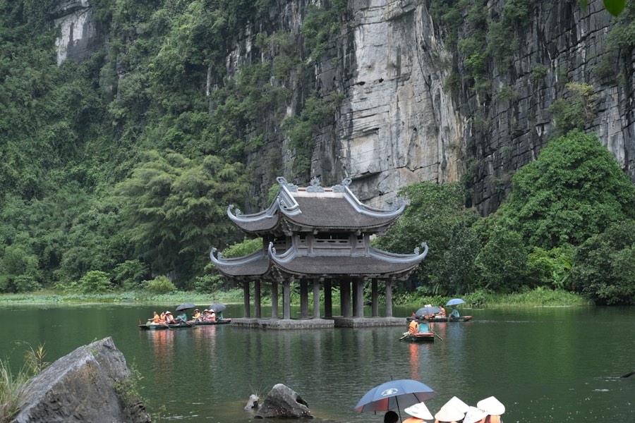 Small boats on a lake surrounded by karst mountains, Ninh Binh, Vietnam