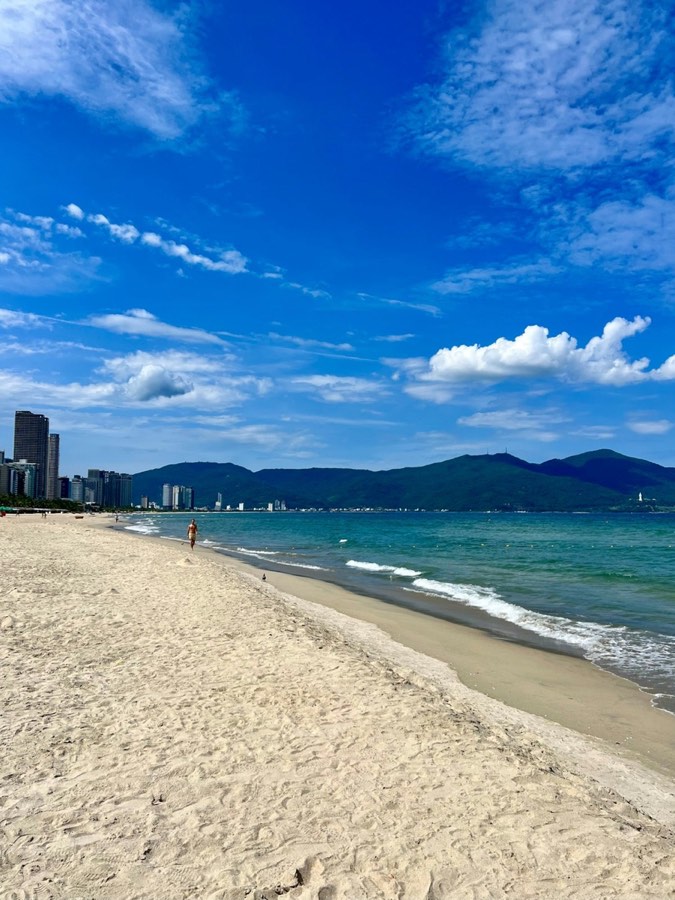 Da Nang beach with white sand and city skyline in the background, Vietnam