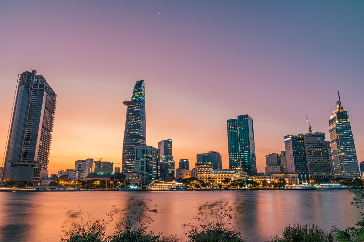 Ho Chi Minh City skyline at sunset reflected in the Saigon River