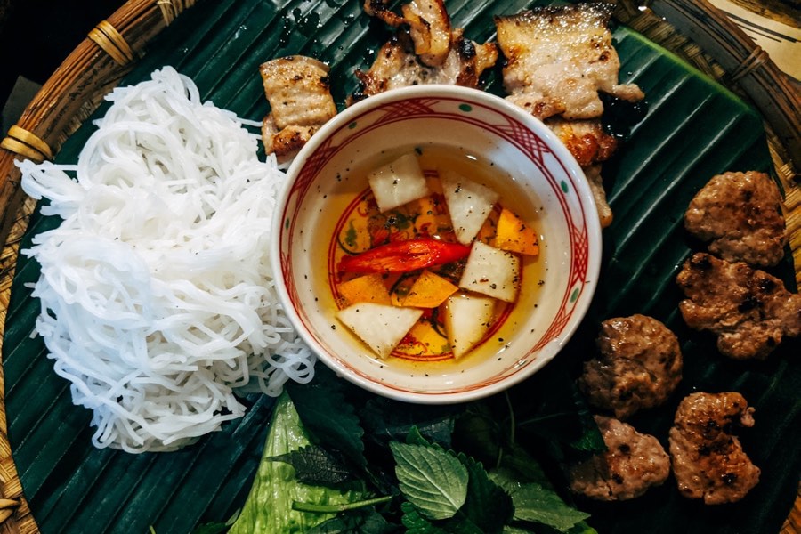 Vietnamese broken rice (com tam) with grilled pork and dipping sauce, Ho Chi Minh City